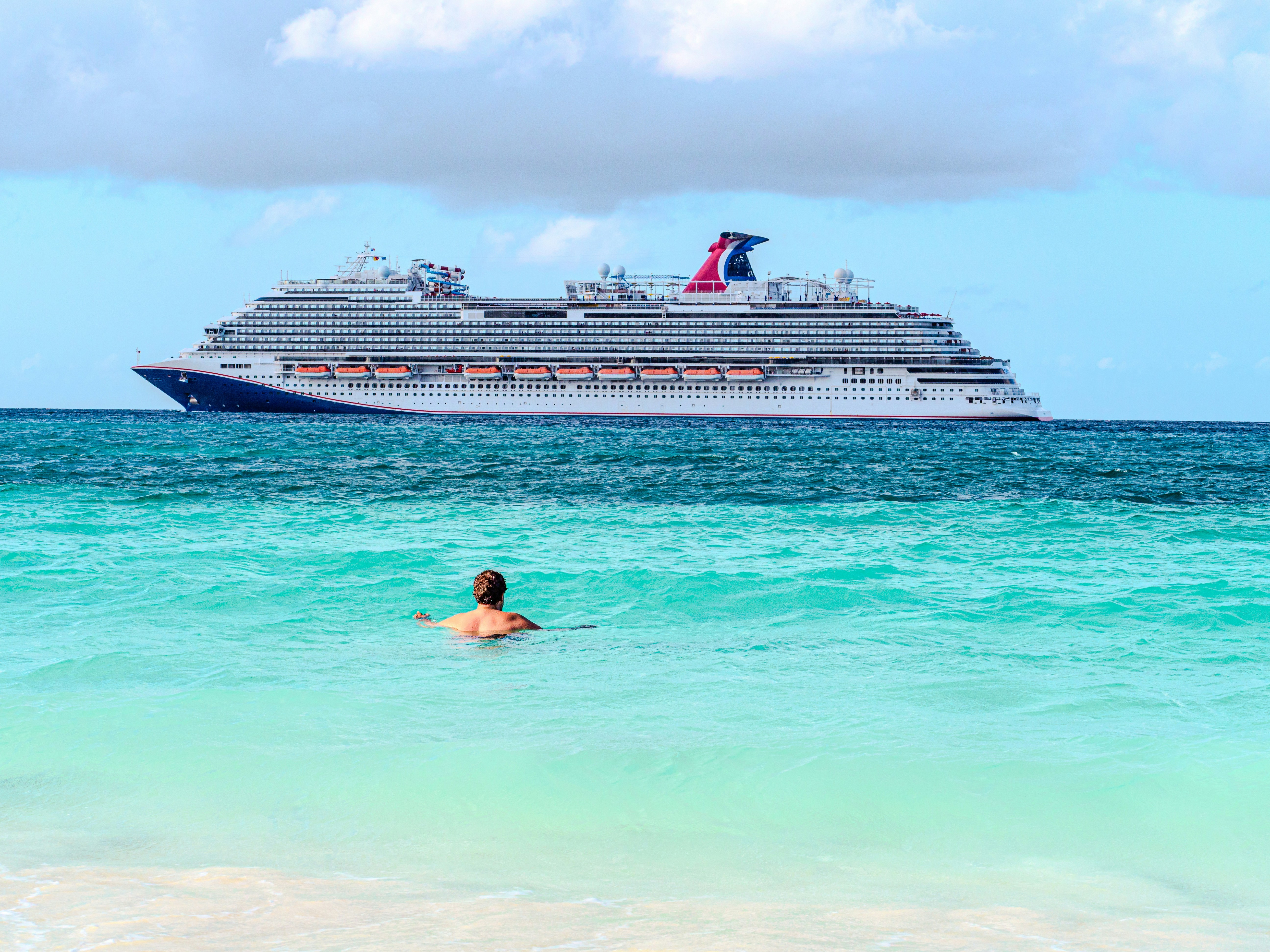 large cruise ship passes from a beach
