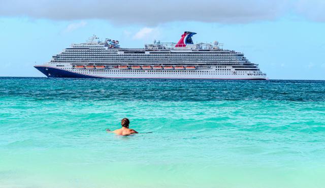 large cruise ship passes from a beach